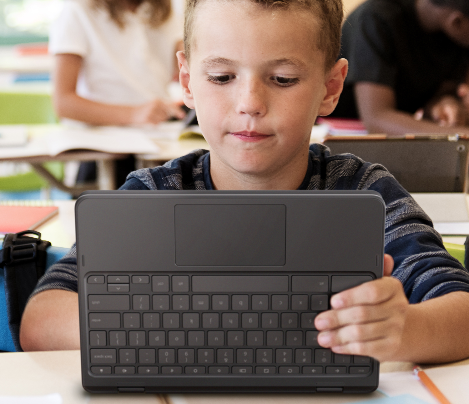 Kid with chromebook in school