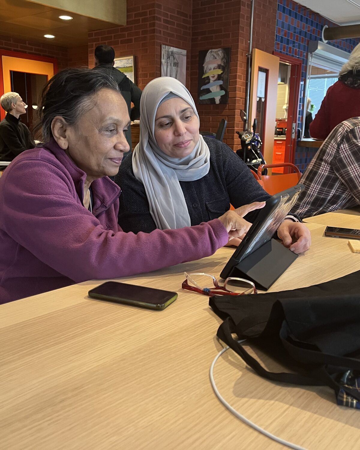 man and woman sitting with ipad